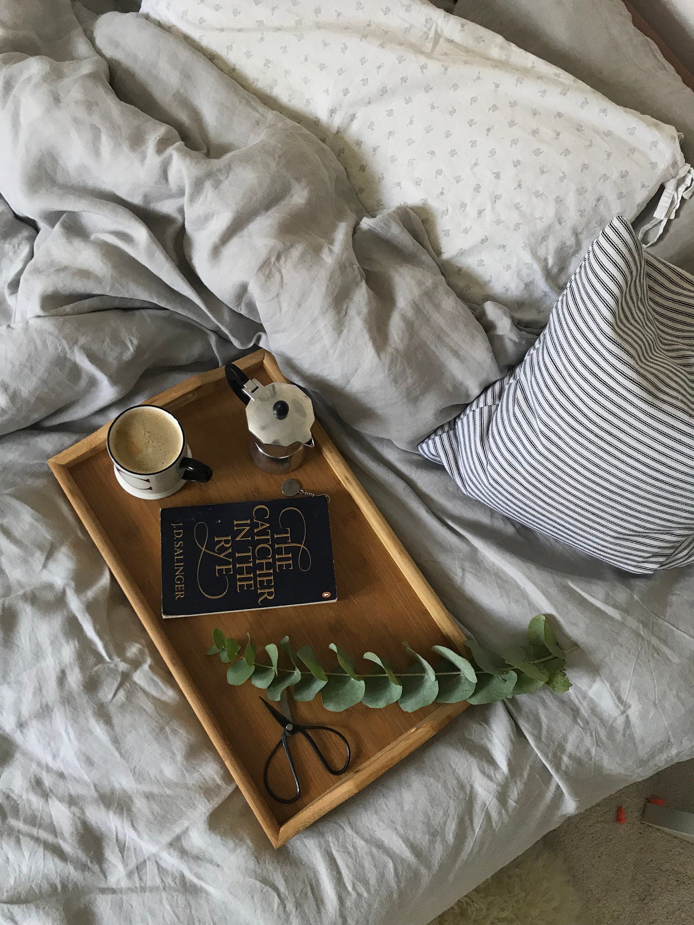 striped pillow cover on a linen bed