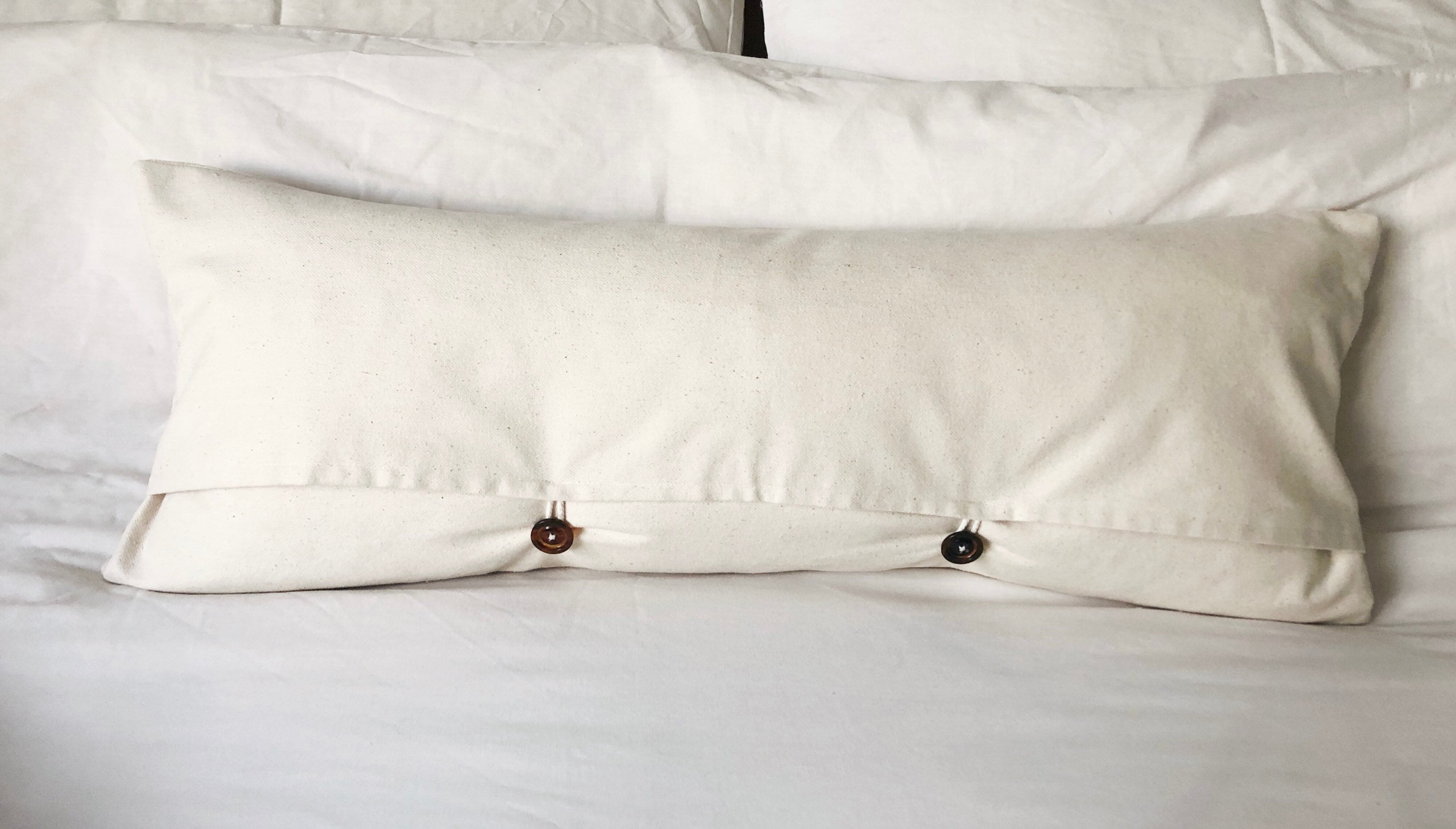 extra long rust patterened lumbar pillow cover, with buttoned reverse