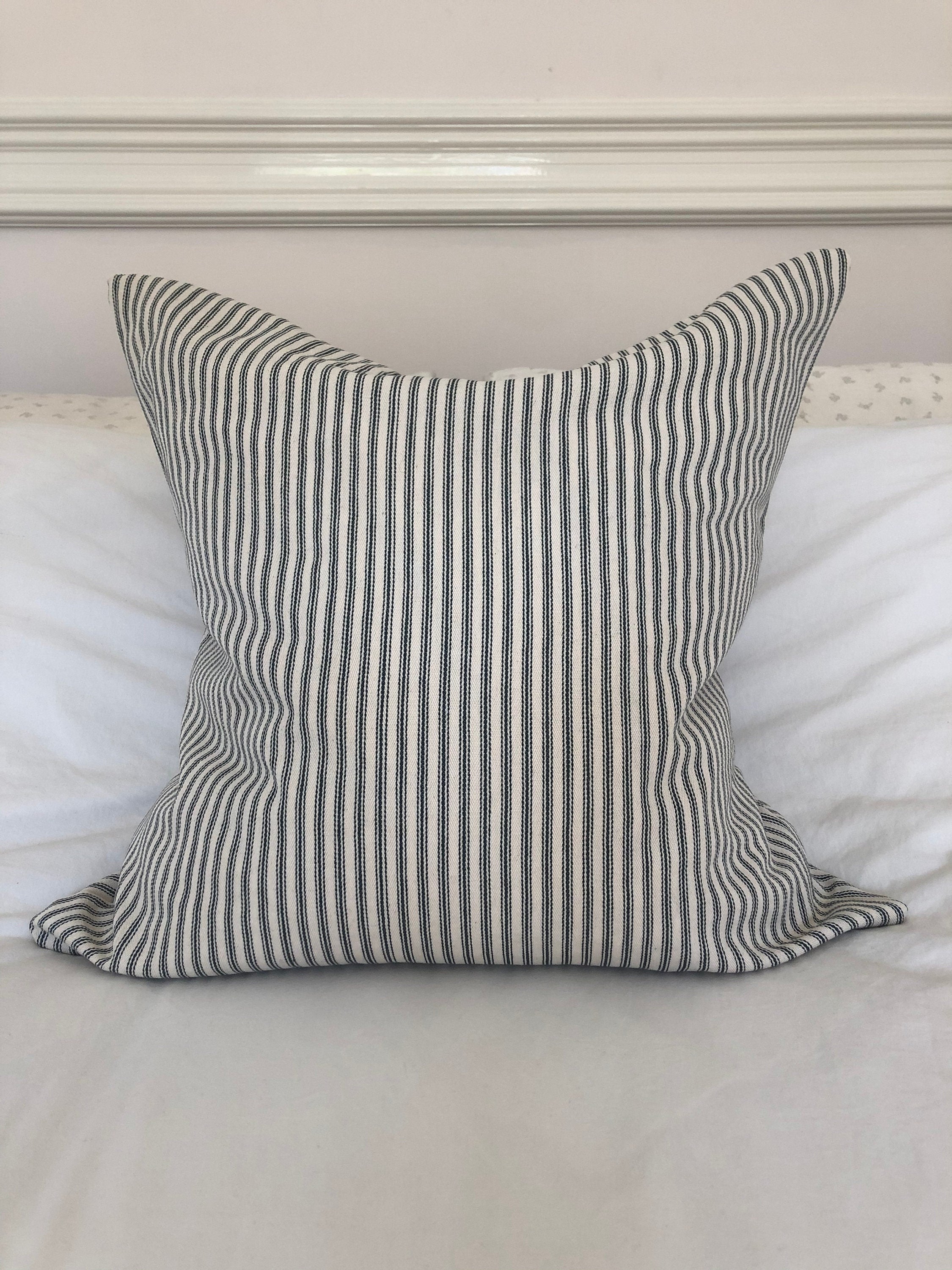 charcoal grey ticking cotton cushion on a white bed