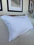white 12x20 linen bolster pillow on bed