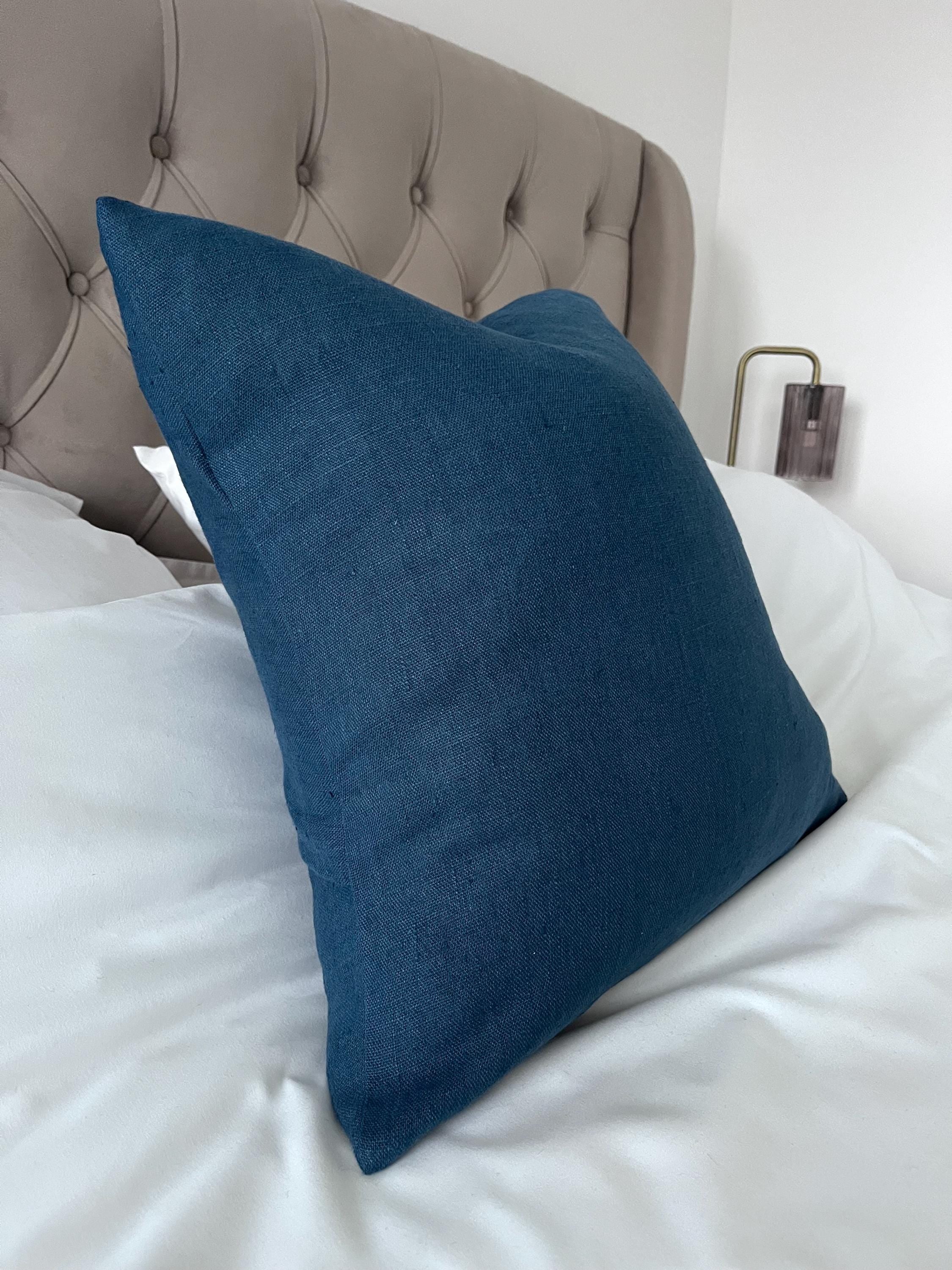 inky blue cushion cover on a bed of white linen