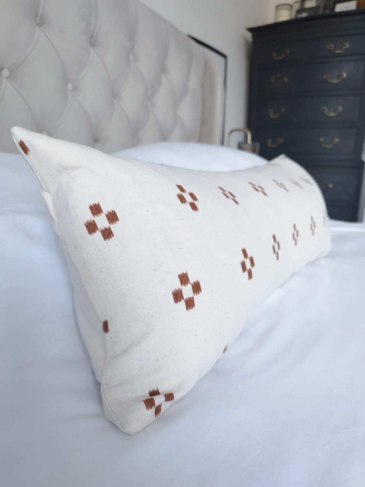 extra long rust patterened lumbar pillow cover, with buttoned reverse