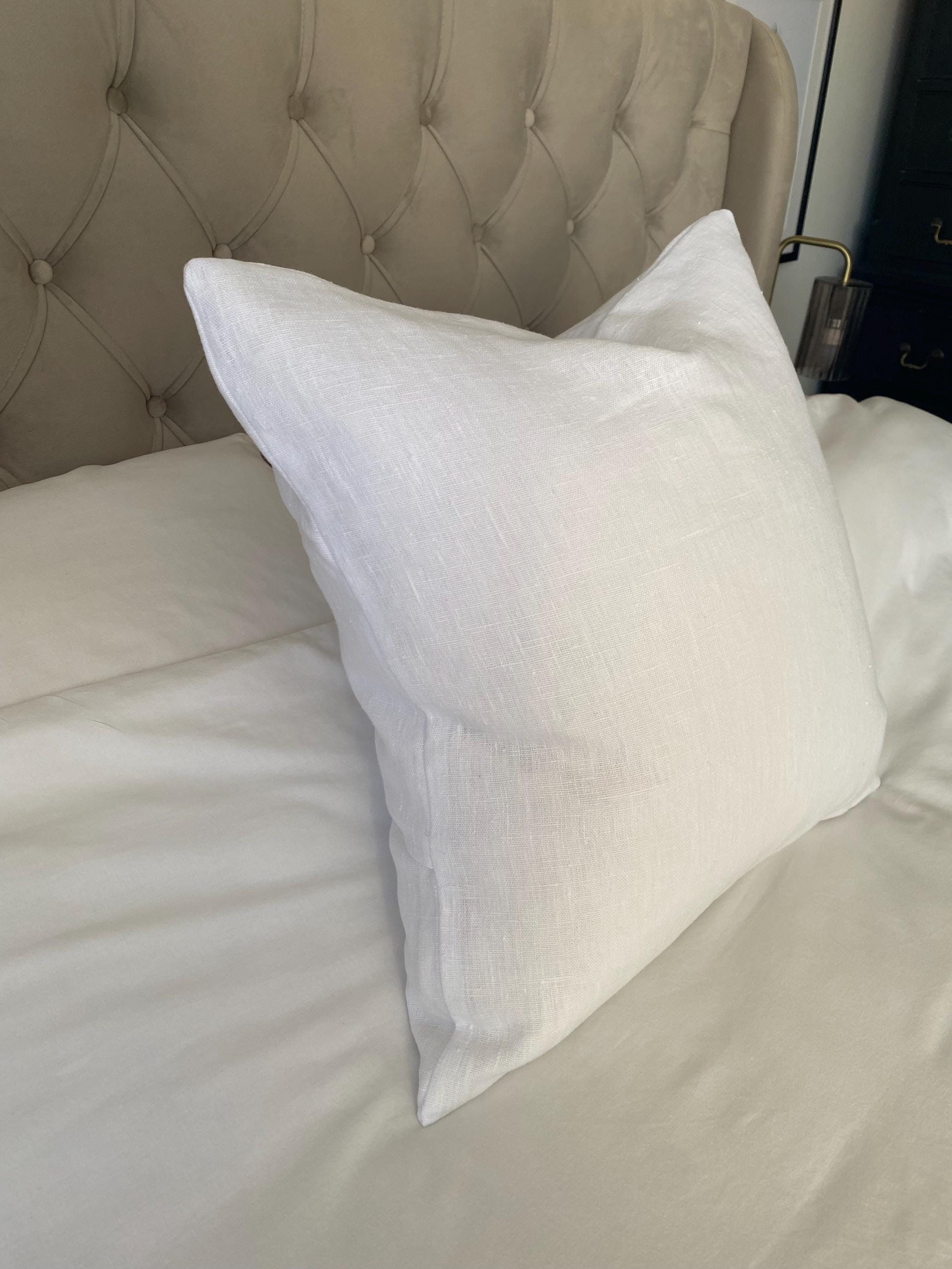 bright white linen pillow on a white bed
